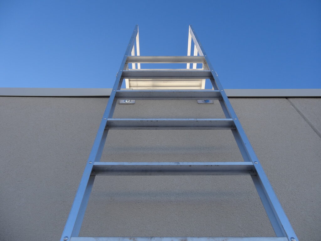 Aluminum fixed ladder attached to a building